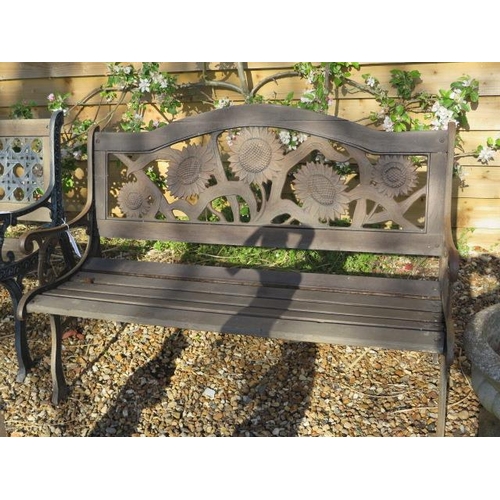 45 - A weathered cast iron sunflower back wooden slatted bench, 127cm wide