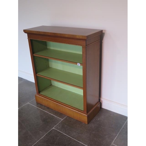 22 - A new walnut bookcase with two adjustable shelves and painted interior, made by a local craftsman to... 