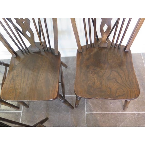 55 - A set of four early 20th century wheelback dining chairs in good polished condition