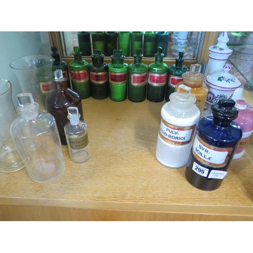 295 - A coloured group of 14 chemist bottles, 3 glass measures and 3 ceramic jars, all but one of the gree... 