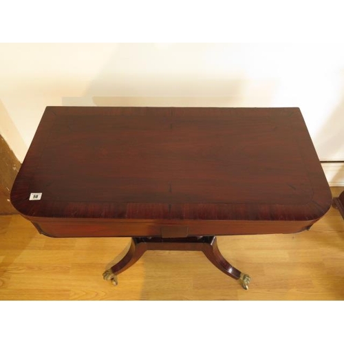 58 - A 19th century mahogany foldover card table on four pillar support and splayed legs on brass hairy c... 