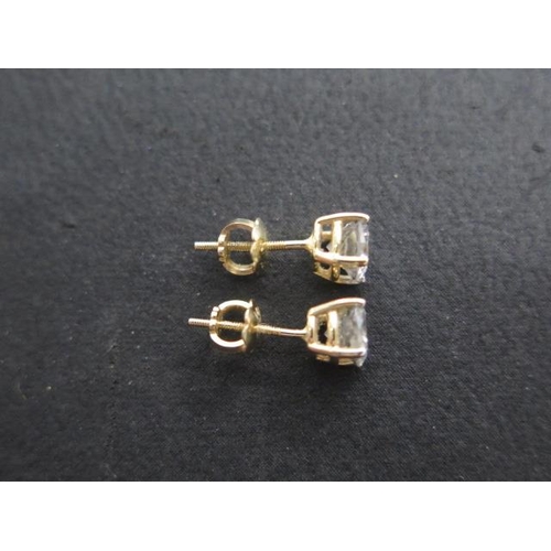 618 - A pair of 14ct yellow gold diamond earrings total estimated 1.16ct, marked 14K, with screw stud back... 