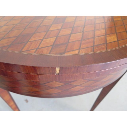 66 - An Edwardian parquetry fold over demi-lune card table on square tapering legs, 75cm tall x 80cm, gen... 