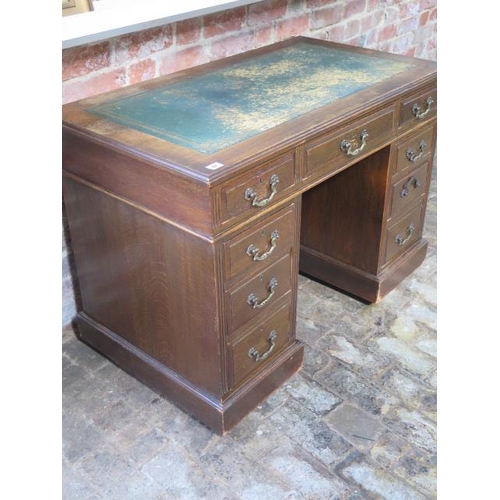 67 - A late Victorian / Edwardian oak 9 drawer twin pedestal desk with a leather insert top, 75cm tall x ... 