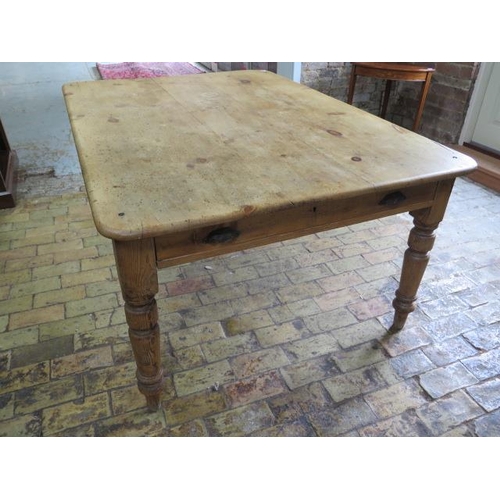 73 - A Victorian stripped pine table with two end drawers and a side drawer on turned legs, 77cm tall x 1... 