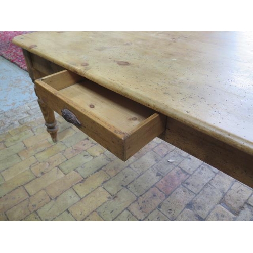 73 - A Victorian stripped pine table with two end drawers and a side drawer on turned legs, 77cm tall x 1... 