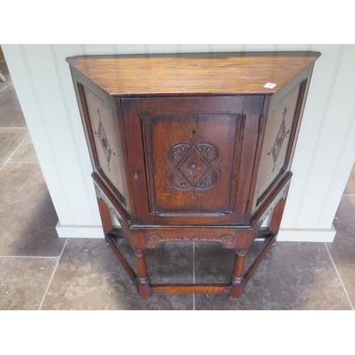 77 - A carved oak cupboard with a single door, back panel missing, 79cm wide