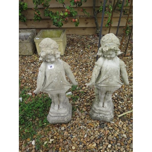 9 - A pair of stone effect statues, 62cm tall