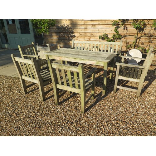 22 - A Barlow Tyrie garden table , bench and four armchairs in nicely weathered condition , table 70 cm t... 