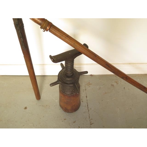 303 - A vintage flail, total length 194cm, and a vintage wagon jack 51cm tall
