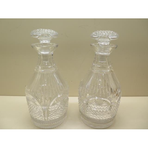 304 - A pair of good quality cut glass decanters, 25cm tall, one has a small chip to rim and small chips t... 