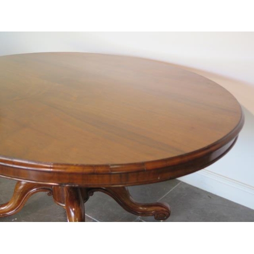 51 - A good 19th century rosewood breakfast table with an oval 152cm x 120cm top on a carved quatrefoil s... 