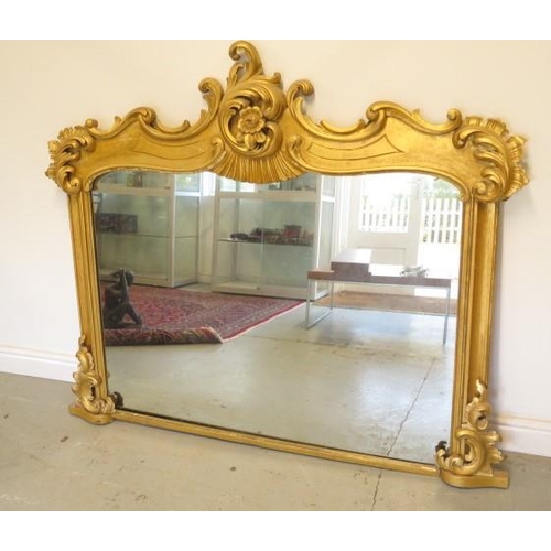 54 - An ornate gilt over mantle mirror, 130cm tall x 152cm wide, in need of some restoration