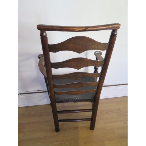60 - An antique, circa 1800, ash and elm ladder back elbow chair with leather seat in polished condition,... 
