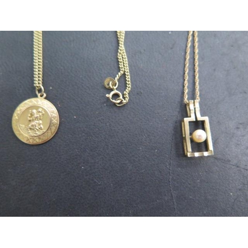 610 - A 9ct yellow gold St Christopher on a 60cm chain and a 9ct pearl pendant on a 42cm chain, ring broke... 