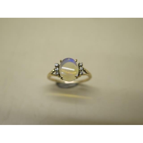 624 - A yellow metal ladies dress ring incorporating a single cabochon cut pale opal, size approx 10mm x 8... 