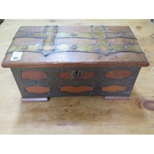 63 - An oak brass bound box with iron carry handles, 23cm tall x 49cm x 25cm