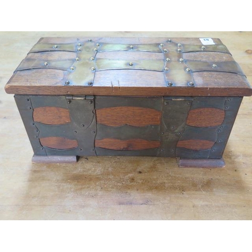 63 - An oak brass bound box with iron carry handles, 23cm tall x 49cm x 25cm