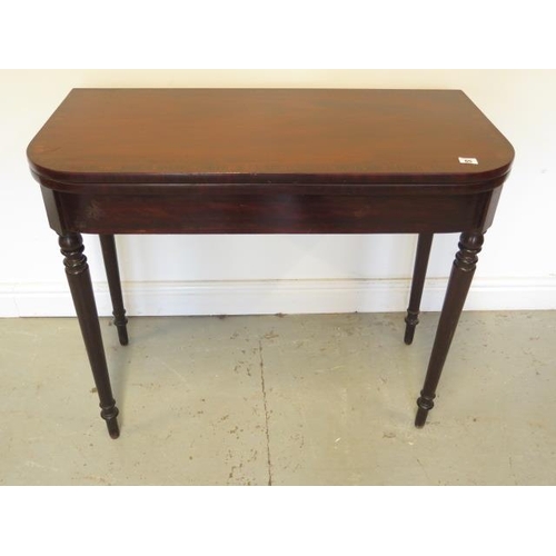 65 - A 19th century mahogany fold over card table on turned legs, 75cm x 92cm