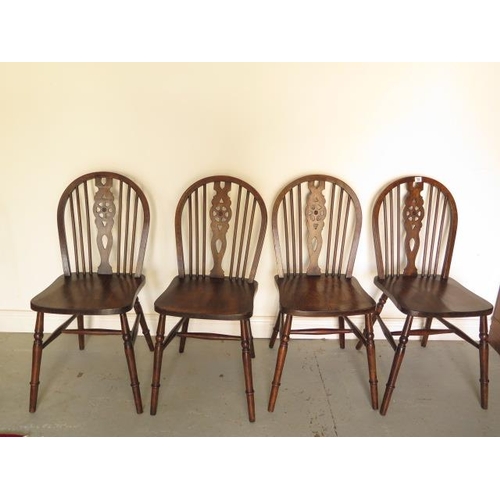 72 - A set of four early 20th century wheelback dining chairs in good polished condition