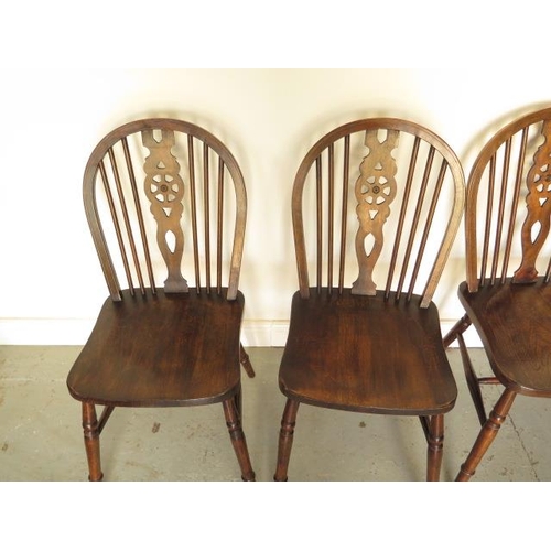 72 - A set of four early 20th century wheelback dining chairs in good polished condition