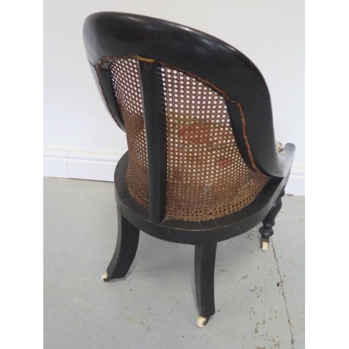 75 - A Victorian ebonised bergere child's chair with mother of pearl inlay, 76cm tall