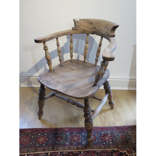 83 - A Victorian smokers bow armchair with double turned stretchers