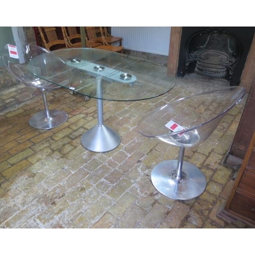 31 - A glass and metal dropleaf breakfast table and a pair of Phillippe Starck design perspex swivel chai... 