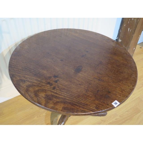 56 - A Georgian mahogany tripod table with a single piece top on a wrythern turned column and splayed fee... 