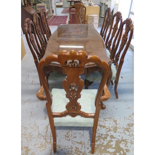 64 - A shaped walnut dining table with a carved frieze on carved cabriole legs having 8 matching dining c... 