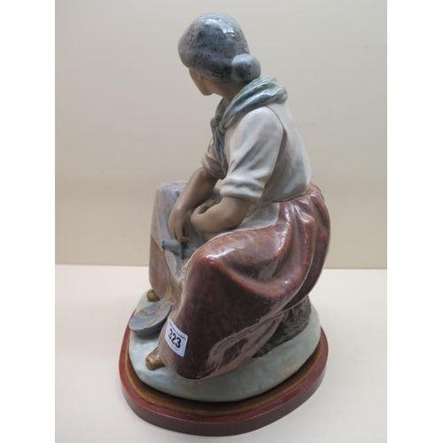 323 - A Lladro Vincente Martinez figure, The Fisherwoman, issued 1978 retired 1985, 40cm tall, on stand in... 