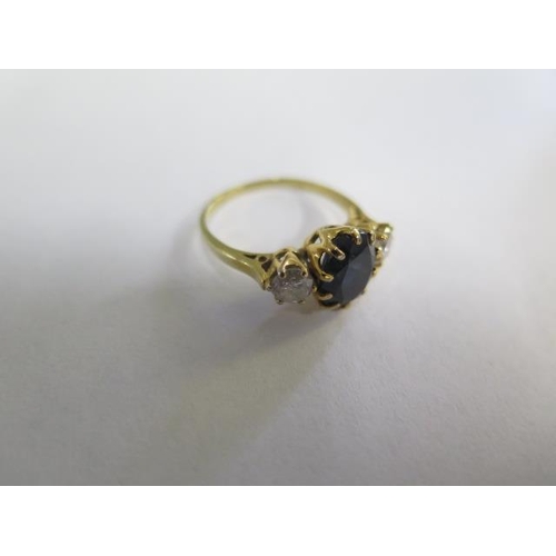 643 - An 18ct yellow gold sapphire and diamond three stone ring, size J/K, sapphire approx 8mm x 7mm x 4.5... 