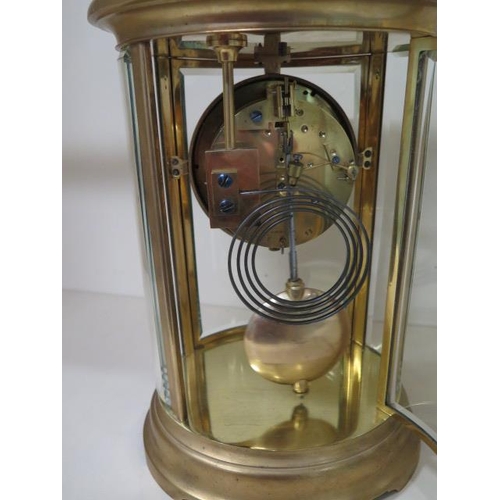 153 - A French oval four glass mantle clock, 27.5cm tall x 19cm wide, striking on a single gong, in good w... 