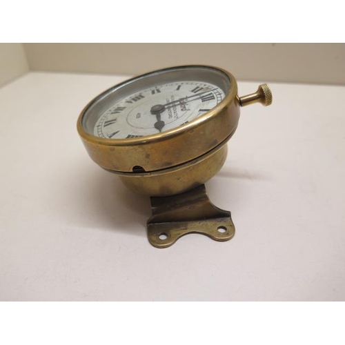 154 - Watford: An early car clock of brass construction with footboard angled mount, the 9cm diameter silv... 
