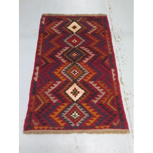 210 - A hand knotted woollen new Baluchi rug, 136cm x 84cm