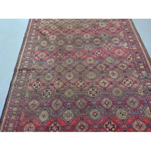 212 - A hand knotted woollen Baluchi rug, 2.95m x 1.6m