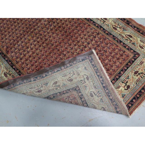 217 - A hand knotted woollen Araak rug, 1.90m x 1.28m