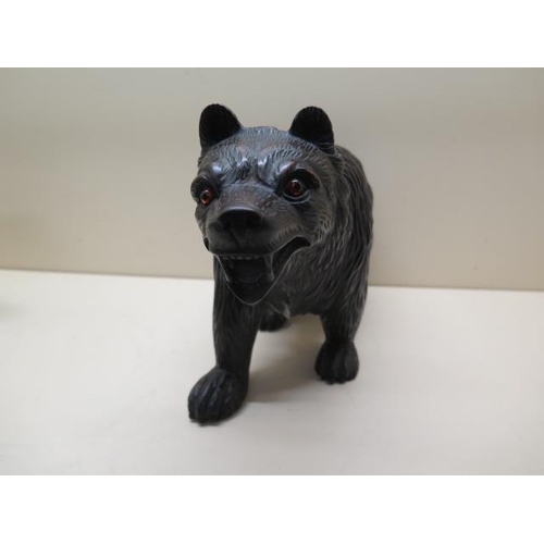 309 - A well carved Black Forest bear with glass eyes, 21cm tall x 34cm long, in good condition
