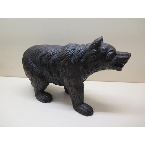 309 - A well carved Black Forest bear with glass eyes, 21cm tall x 34cm long, in good condition