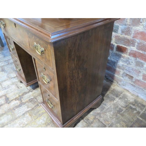 73 - A walnut kneehole desk with five drawers and a cupboard also with a mahogany toilet desk mirror, 77c... 