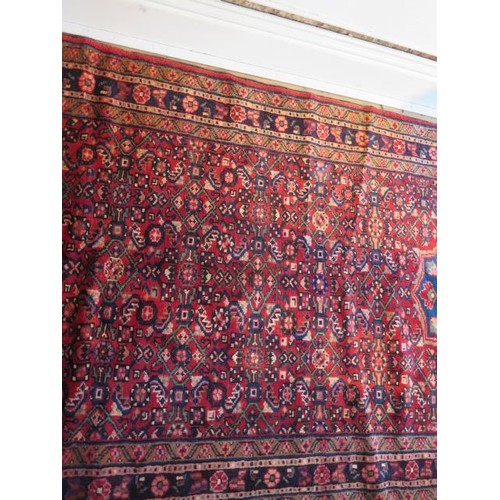 221 - A hand knotted woollen Hamadam rug, 4.10m x 1.10m