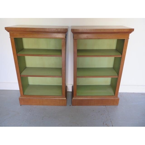 10 - A pair of new walnut bookcases with adjustable shelves and painted interior, made by a local craftsm... 