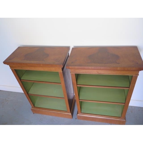 10 - A pair of new walnut bookcases with adjustable shelves and painted interior, made by a local craftsm... 