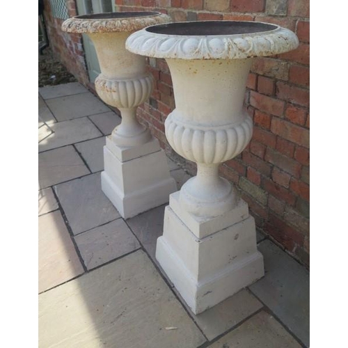 15 - A pair of cast iron garden urns on stands, 111cm tall x 57cm diameter