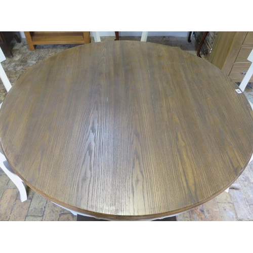 32 - A shabby chic circular dining table on a square tapering column and quatrefoil platform base and 4 m... 