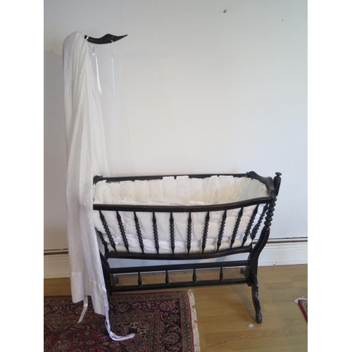 60 - A Napoleon III swan neck bobbin turned cradle on stand with covers, 161cm tall x 120cm