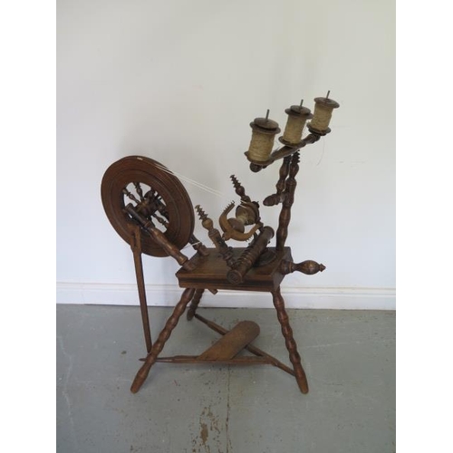 61 - A 19th century spinning wheel with triple gallery