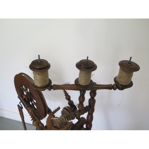61 - A 19th century spinning wheel with triple gallery