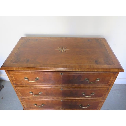 66 - A reveneered 3 drawer chest with star inlay, standing on shaped bracket feet, 90cm tall x 95cm x 50c... 