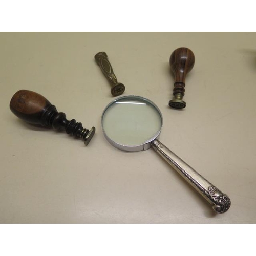 314 - Three seal stamps and a silver handled magnifying glass